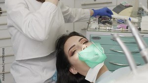 The doctor dentist woman treats teeth with a drill to a patient. Dental clinic 4K Stock Video