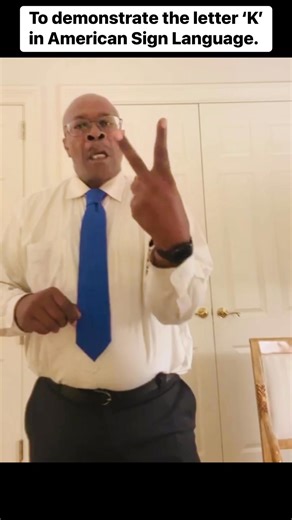 The letter K is signed by holding up your dominant hand, palm facing out, with your index and middle fingers sticking up like the letter 'V' (or like the common "peace" sign), while your thumb is placed @ # at the base of the two extended fingers. #ASL #LetterK #SignLanguage | Clarence Houge