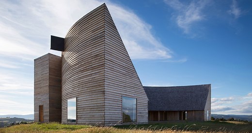 pezo von ellrichshausen's crescent-shaped house in chile provides shelter from the elements