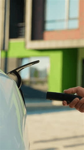 clip-3988902063-person-charging-electric-car-public-station