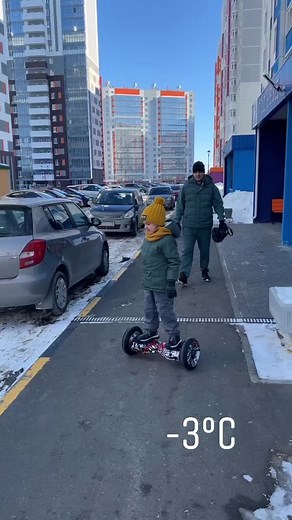 Child Learning Balance on Hoverboard in Cold Weather