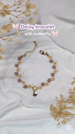 Daisy Bracelet with butterfly charm | beaded bracelet making Go to my YouTube channel for a full tutorial (Linlin Crafty) #beadedbracelets #makingbracelets #handmadejewelry #daisybracelet | Linlin Crafty