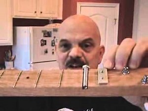 Adjusting the string height on a Cigar Box Guitar