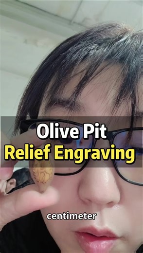 olive pit engraving relief marking on fruit pit.