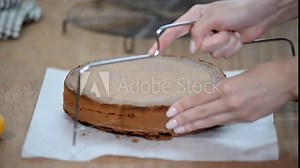 Sponge-cake and threads cutting. Making layer sponge cake.