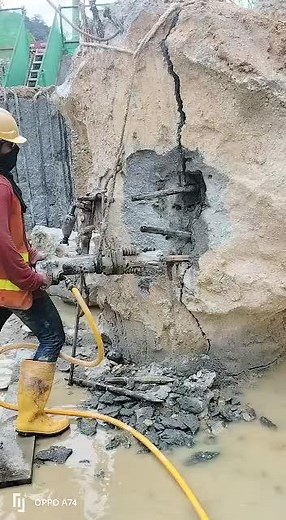 Construction Worker Operating Drilling Tool Safely
