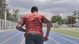 Man from behind running in a sports center - Free Stock Video