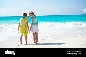 Adorable little girls walking on the beach. Back view of kids together enjoy sea view Stock Video Footage - Alamy