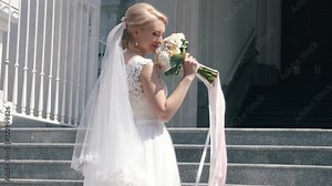 Beautiful bride posing near the temple. Go next to the letter in your hands. A romantic wedding.