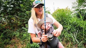 Young parents take their baby to catch his first fish