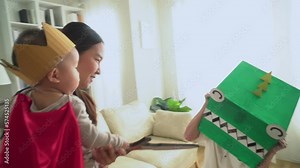 Asian old grandpa with toy mask playing with baby grandson on knight suit at home. happy family with good relationship concept