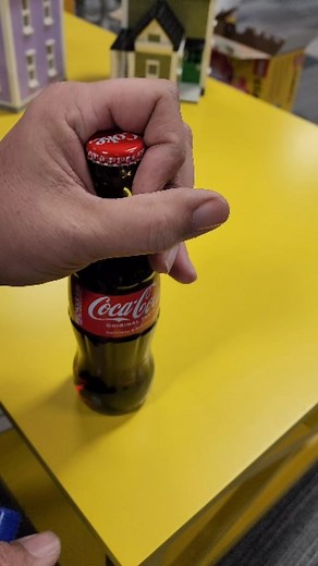 Bevins Bricks on Instagram: "Old school way to open a pop bottle without a bottle opener. #oldschool #pop #coke #bottle #opener #open #soda"