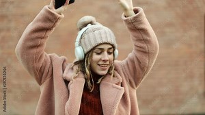 Young girl dancing to the music outdoors