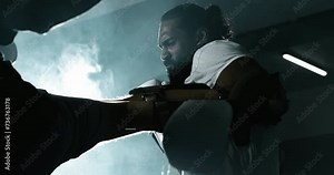 Fighter defends himself against leg strike inside boxing ring in dramatic fighting cinematic scene in super slow-motion at 800 fps captured with high-speed camera