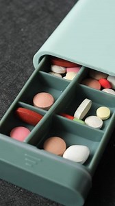 Download A pill box with many compartments and pills for free
