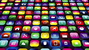 Multimedia screen display showing a collection of colorful apps icons background