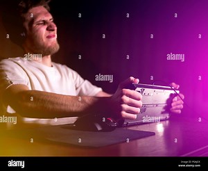 young mad crazy gamer breaking the keyboard playing video games on computer late in the night Stock Photo - Alamy