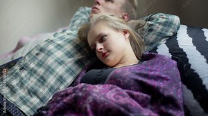 Couple lying together on the bed and talking with each other