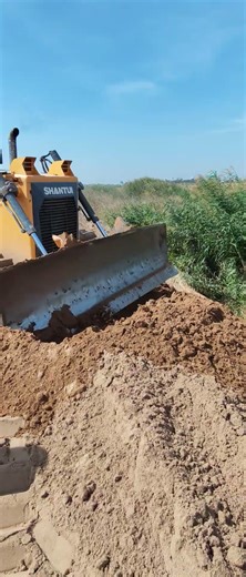 Stronger Bulldozer Pushing Clearing Access Road On Construction.