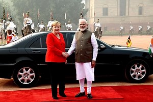 German Chancellor Angela Merkel sits during national anthem – Read this before you outrage