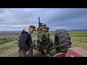 Threading new wire through a IH 47 hay baler.
