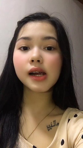 Exploring Arabic Script Tattoos on Neck and Chest