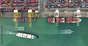 logistic container ship and commercial port loading and unloading cargo from container ship import and export by crane for distributing goods by trailers transported, 4k video drone point of view,