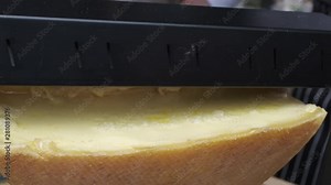 Street food vendor sell raclette - Swiss dish, also very popular in Savoie (France), based on heating the cheese and scraping off the melted part.