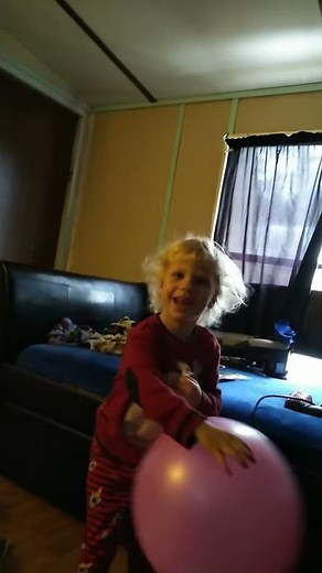 Junior punching the pink punch balloon