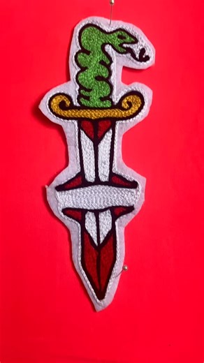 @paco_patches on Instagram: "Handmade chain stitch embroidery patch featuring a snake wrapped around a dagger — a classic symbol of danger, loyalty, and survival. Stitched using a vintage chain stitch machine, following traditional embroidery techniques inspired by old-school tattoo flash and heritage workwear. Bold outlines, saturated colors, and visible stitch texture give this patch a raw, alive character. Each piece is made slowly and individually: slight variations are part of the process a