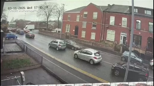 Moment police van on 999 call crashes into parked cars