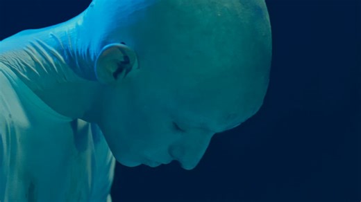 A bald pale-skinned alien making eerie moves looking for his prey - Free Stock Video