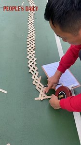 83K views · 1.2K reactions | Elementary school students created a colorful 30-plus-meter popsicle stick bomb in Hangzhou, E China's Zhejiang. | People's Daily, China | Facebook