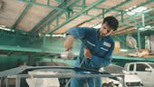 Latin Male Technician Using Spray Compressor Painting Automotive...