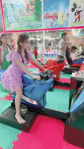 Young Player Enjoys Motorcycle Arcade Game Experience