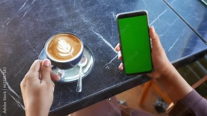 holding a cpu of coffee and using smart phone with green screen
