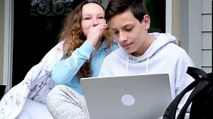 hands of a computer sit on the porch cover yourself with a blanket laugh sincerely teenagers communicate interesting stories gossip stories discussion conversation