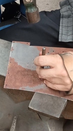 Starting on a great helm. Before I drill at the holes I use a punch to make a little dent which will keep the drill from walking where it's not supposed to. #azurearmoury #wip #handmade #chisel #helmet | Azure Armoury