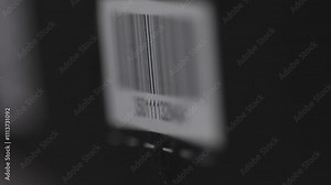 close-up of a barcode being scanned with a laser beam barcode scanner, a barcode on a parcel or product being scanned with a laser