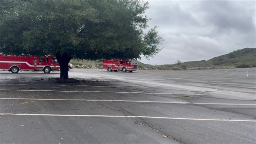 An elderly woman survived after being swept away by water near Lake Hodges Thursday morning. A man called 911 at about 8:10 a.m. to report that he and his wife were walking arm in arm through water when she was swept away by a strong current. Authorities responded, establishing a significant rescue effort with assistance from multiple agencies. Rescue personnel worked for about an hour to find the missing woman but could not successfully locate her. A helicopter from the San Diego Fire-Rescue De