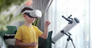 Child learning using virtual reality headset. Education child in virtual reality glasses. Close-up face with smile. Little boy Immersed in cyberspace, learning in virtual reality. Kid playing games