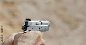 Pistol shooting bullets in slow motion footage. Hand guns in firing range