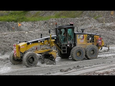 Motor Grader 14M3 Caterpillar Working On Wet Mine Roads