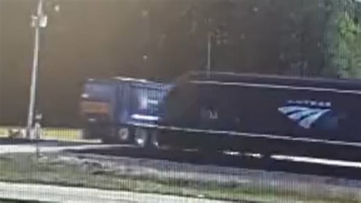Train collides with garbage truck at an unsecured railroad crossing