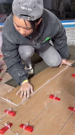 the process of installing wooden planks on the floor