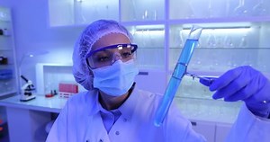 Team of Scientists Researchers Laboratory People Talking Examine Liquid Samples