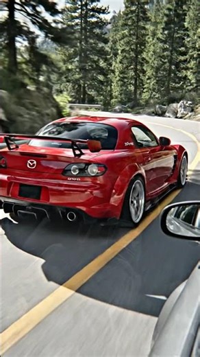 modified Mazda RX-8 car calor red parked in an industrial garage