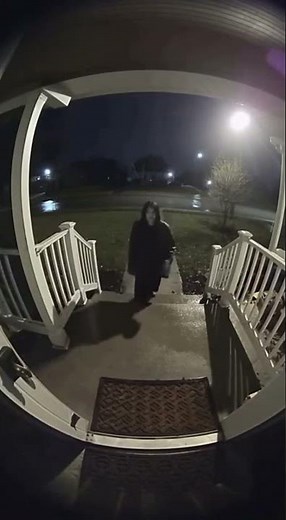 A quiet suburban house recorded through a doorbell camera at night.