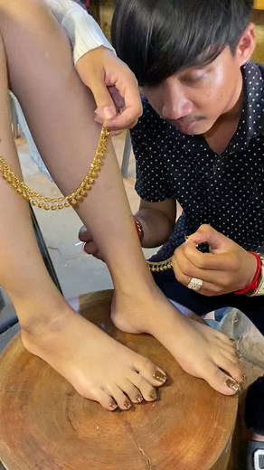 Applying Gold-Colored Anklets: A Close-Up Experience