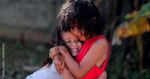 Two sisters hugging each other. Real people love and affection Stock Video